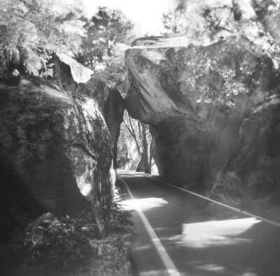 boulders creating a tunnel over a road