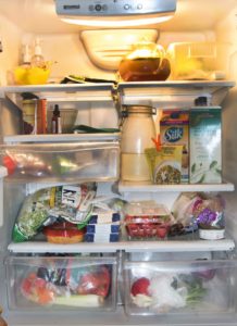 Fridge with milk and vegetables